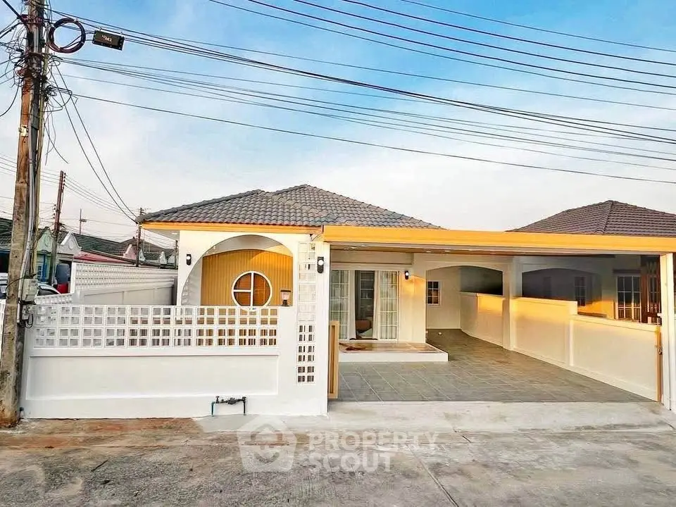 Charming single-story home with modern facade and spacious driveway in a serene neighborhood.