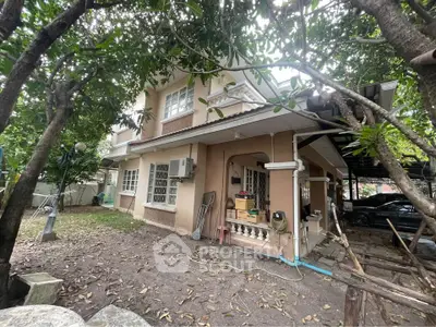 Charming two-story home with lush garden and spacious outdoor area, perfect for family living.