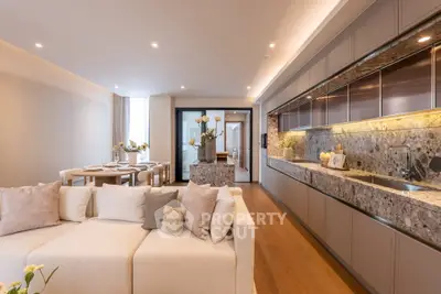 Luxurious open-plan living room and kitchen with elegant decor and modern amenities.