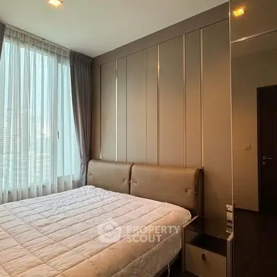 Modern bedroom with large window and stylish decor in urban apartment