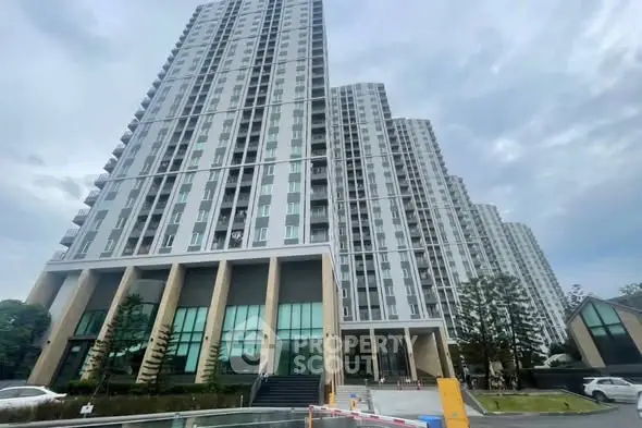 Modern high-rise residential building with sleek architecture and spacious balconies.