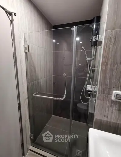 Modern bathroom with glass shower enclosure and sleek fixtures