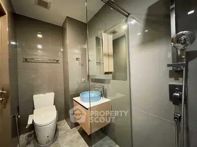 Modern bathroom with sleek fixtures and glass shower enclosure