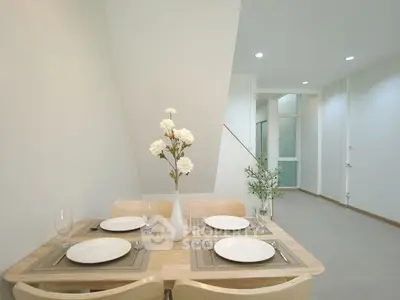 Modern dining area with elegant table setting and minimalist decor