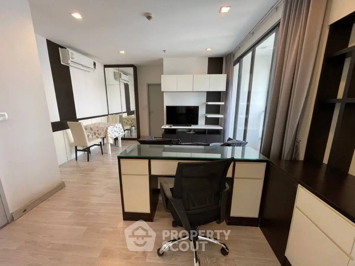 Modern living room with sleek furniture and large windows in a stylish apartment.