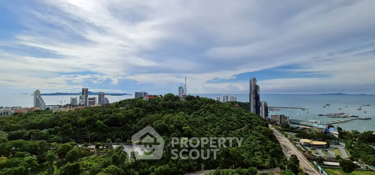 Stunning panoramic view of city skyline and ocean from a high vantage point, perfect for urban living.