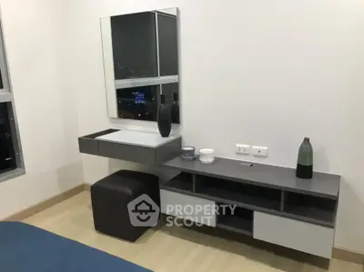 Modern minimalist bedroom with sleek TV stand and large mirror, offering a cozy and stylish living space with city night view.