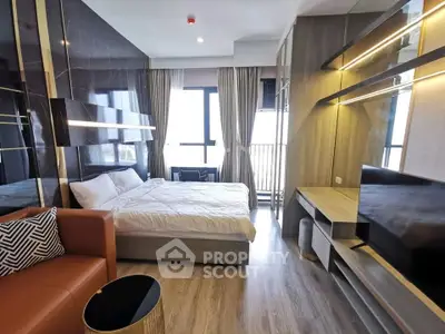 Modern bedroom with stylish decor and large windows offering natural light.