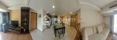 Spacious open-plan living and dining area with modern furnishings and natural light