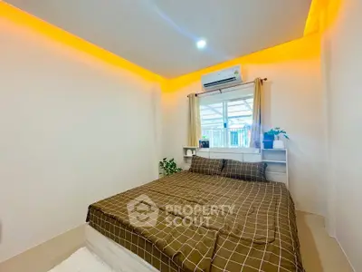 Cozy bedroom with modern lighting and air conditioning, perfect for relaxation.