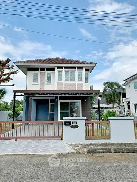 Charming two-story house with modern design and spacious front yard in a serene neighborhood.