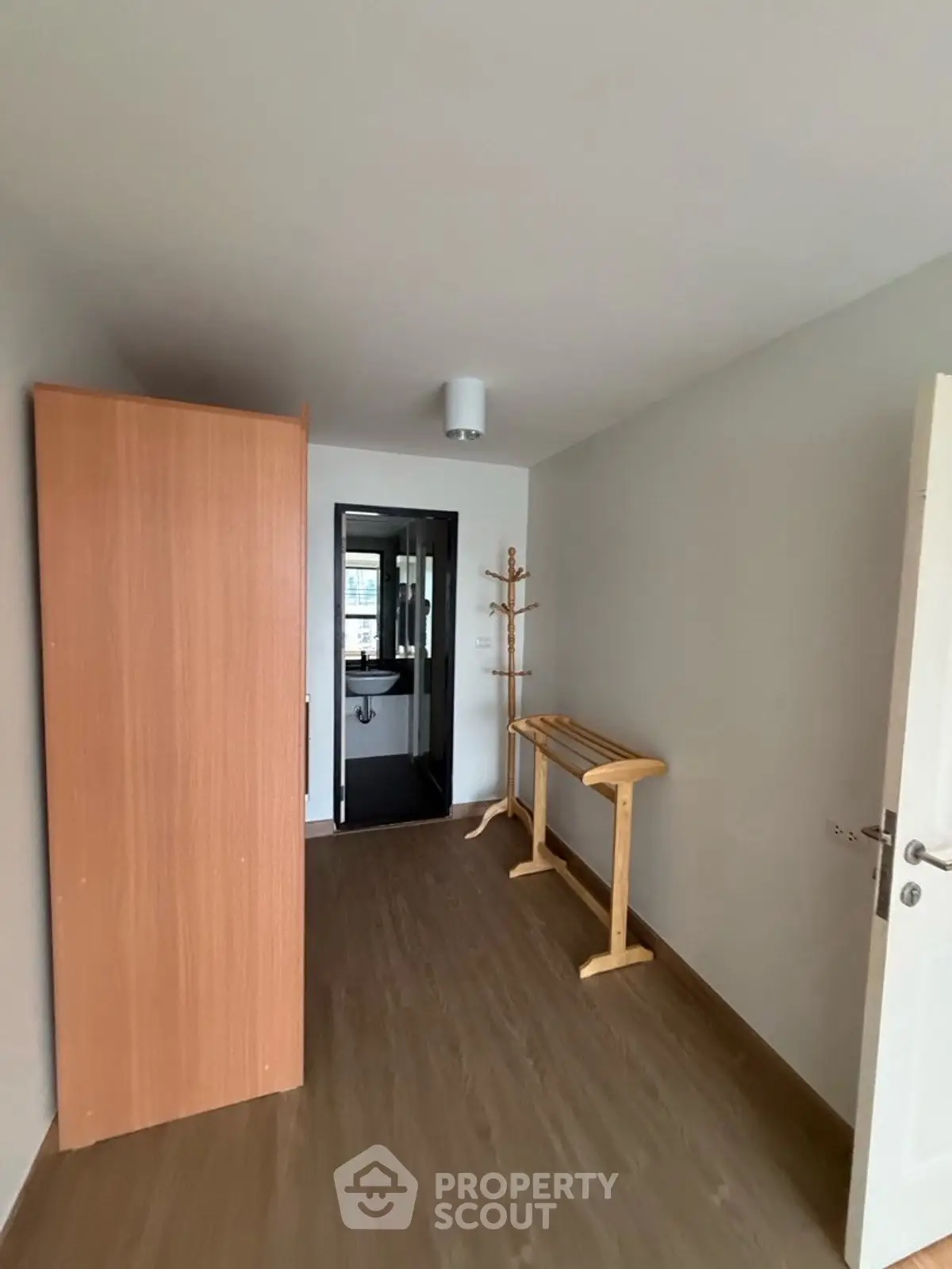 Minimalist interior with wooden flooring and simple furniture