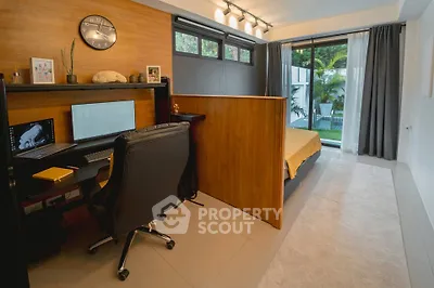 Modern bedroom with study area and garden view, featuring sleek design and natural light.