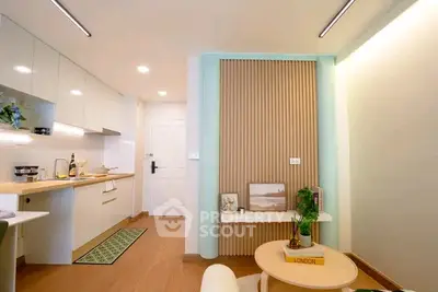 Modern open-layout kitchen and living area with stylish decor and wooden flooring.