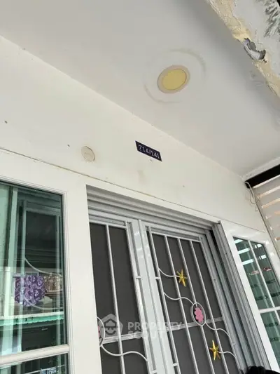 Charming entrance with decorative security door and house number, perfect for welcoming guests.