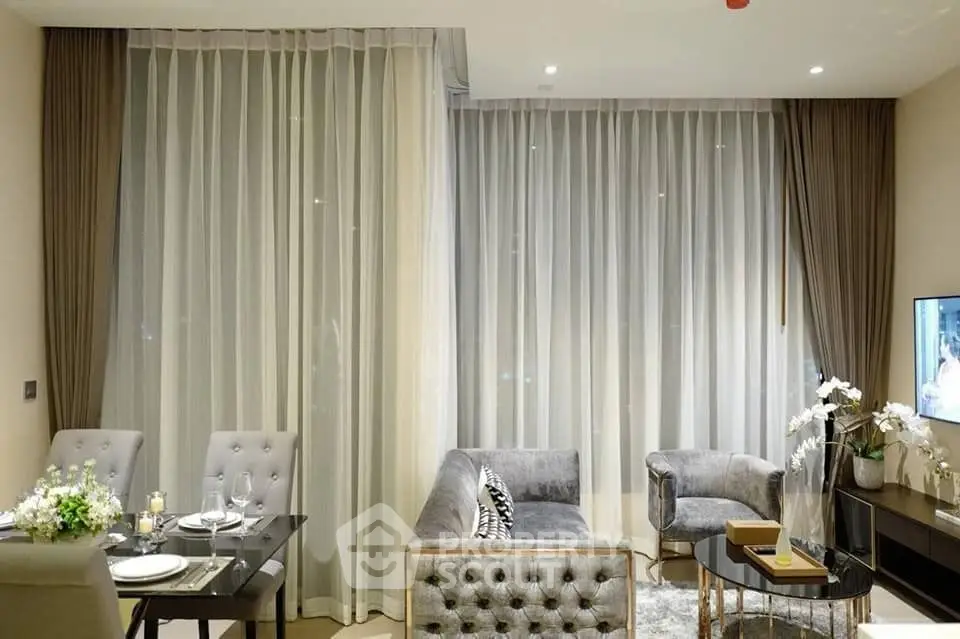 Luxurious living room with elegant furniture and floor-to-ceiling windows in a modern apartment.