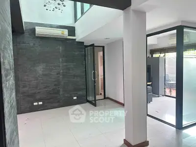 Modern interior space with glass doors and air conditioning, ideal for office or living area.