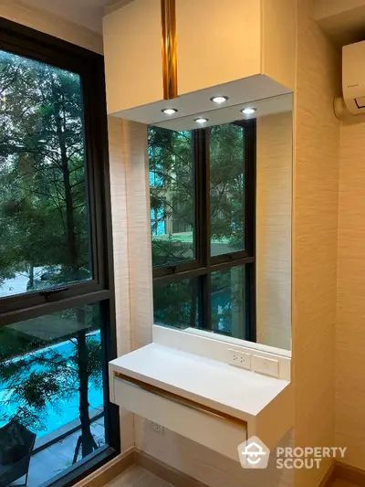 Modern vanity area with large window and pool view in luxury apartment