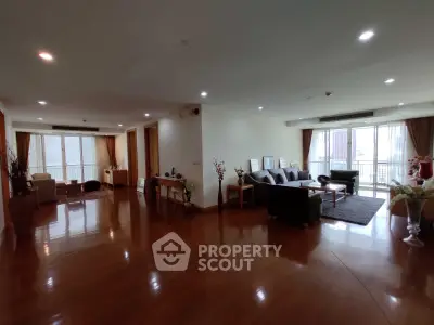 Spacious living room with elegant wooden flooring and modern furniture