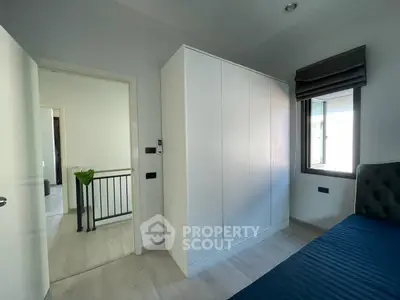 Modern bedroom with sleek wardrobe and natural light