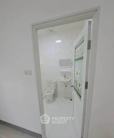 Modern bathroom with floral door design and sleek fixtures