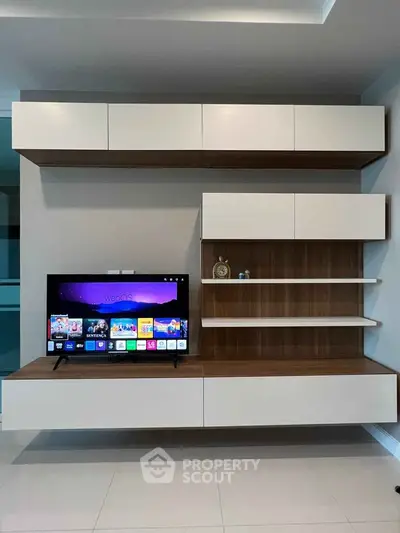 Modern living room with sleek wall-mounted TV and stylish shelving unit