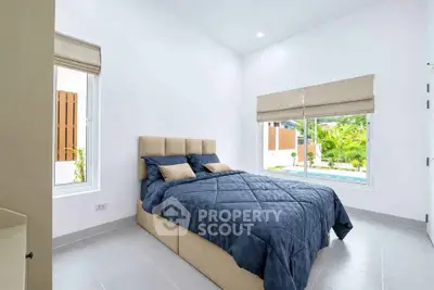 Bright and modern bedroom with large windows and stylish decor