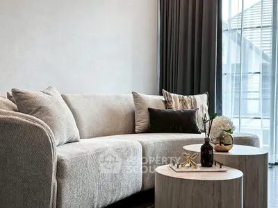 Elegant living room with modern sofa and stylish decor in a bright, airy space.