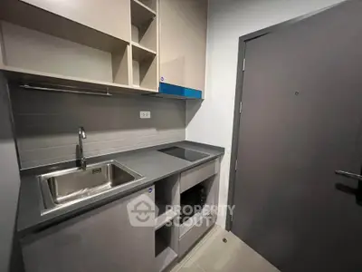 Modern compact kitchen with sleek cabinetry and integrated appliances