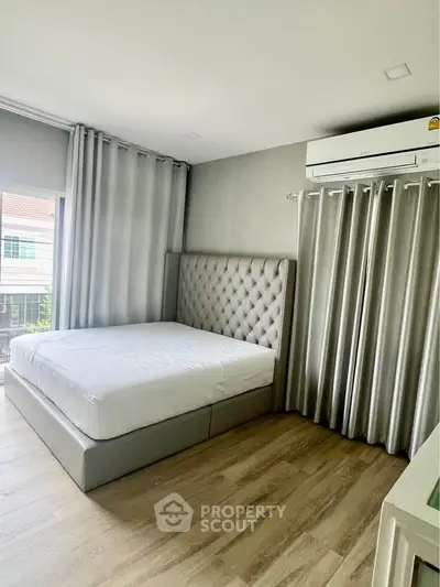 Spacious bedroom with elegant decor and natural light in modern apartment