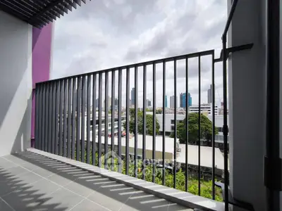 Spacious balcony with city view, perfect for relaxation and enjoying urban skyline.
