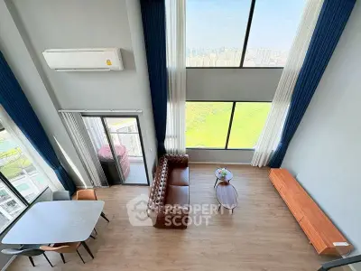 Stunning high-ceiling living room with panoramic city view and elegant furnishings.