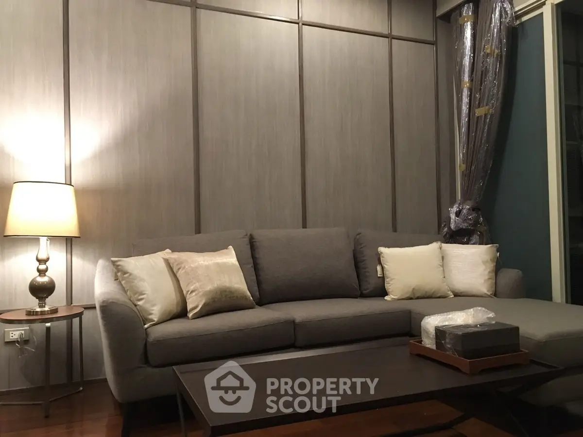 Elegant living room with modern gray sofa and stylish lamp