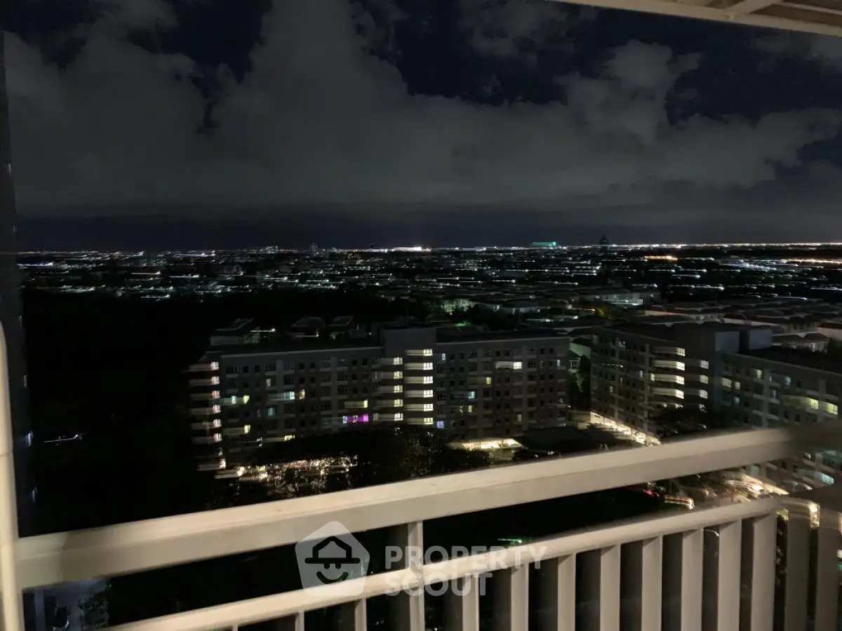Stunning night cityscape view from high-rise balcony overlooking urban skyline.