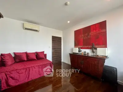 Stylish living room with red accents and elegant wooden furniture.