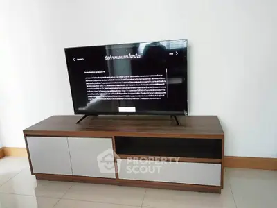 Modern living room with sleek TV stand and flat-screen television