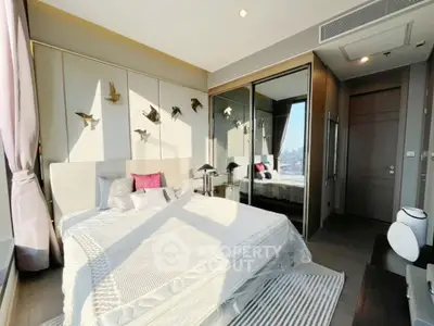 Luxurious bedroom with modern decor and city view, featuring elegant wall art and plush bedding.
