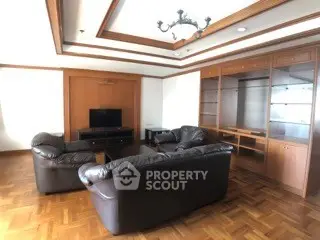 Spacious living room with elegant wooden flooring and leather sofas
