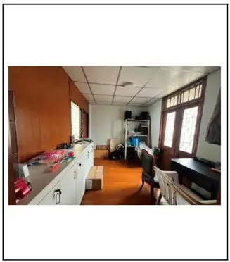 Spacious study room with wooden flooring and ample natural light, perfect for a home office setup.