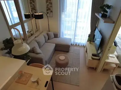 Modern living room with cozy sofa and stylish decor in a bright apartment.