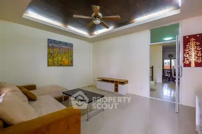 Spacious living room with modern ceiling fan and cozy sofa
