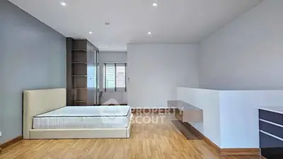 Spacious modern bedroom with minimalist design and wooden flooring