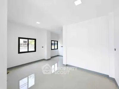 Spacious and bright empty room with large windows and glossy tiled floors, perfect for customization.