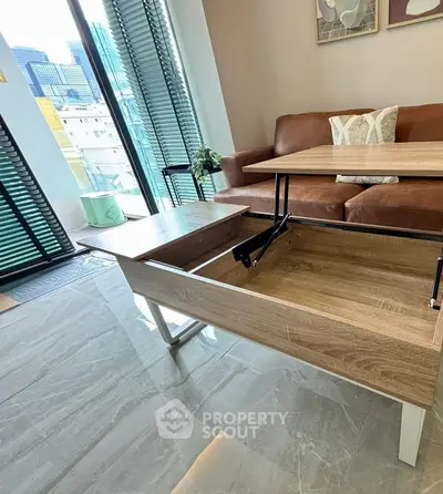 Modern living room with innovative lift-top coffee table and city view.