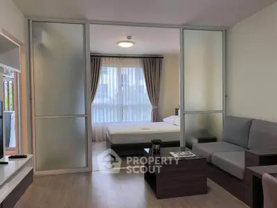 Modern studio apartment with sliding glass doors and cozy furnishings.