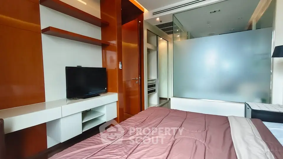 Modern bedroom with sleek wooden shelves and frosted glass partition