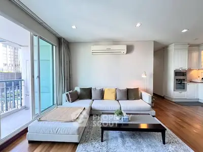 Spacious living room with modern decor and open balcony view