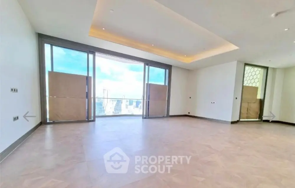 Spacious modern living room with large windows and city view