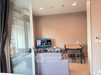 Modern living room with cozy sofa and dining area in open layout apartment