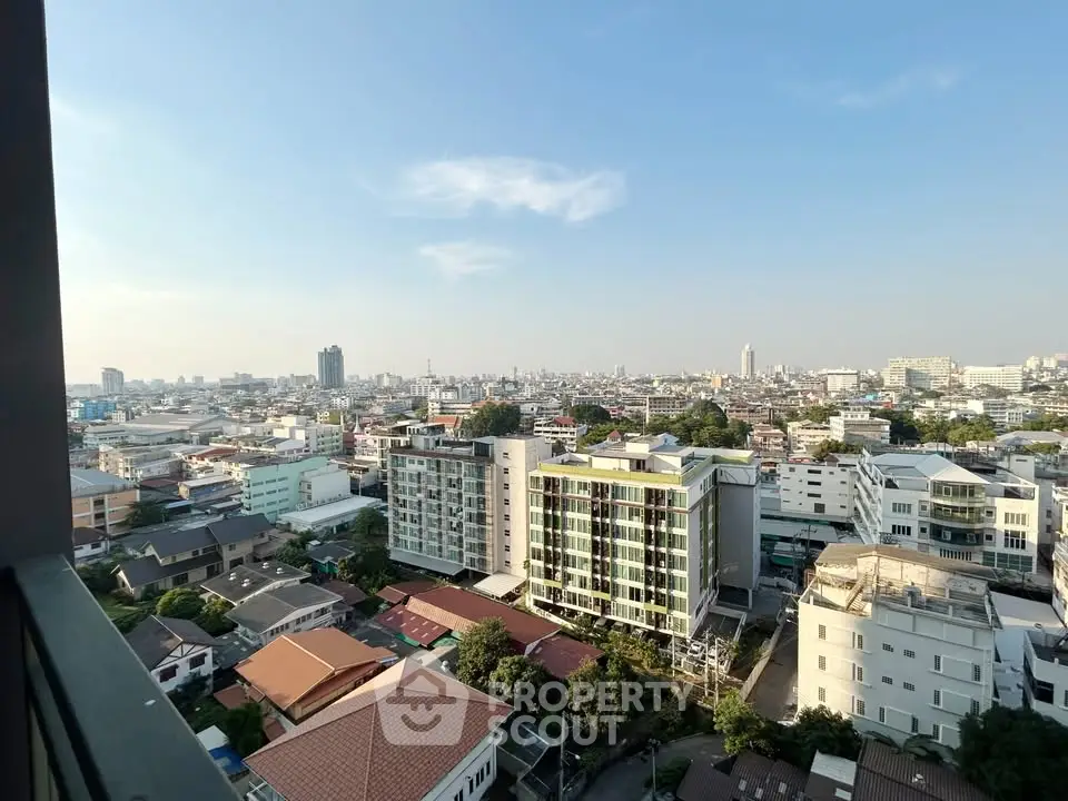 Stunning cityscape view from high-rise balcony showcasing urban skyline and residential buildings.